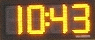LED time and temperature display demonstrating automatic dimming